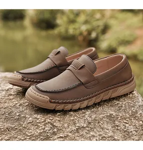 Detailed view of vintage men's brown loafers featuring soft leather and decorative stitching