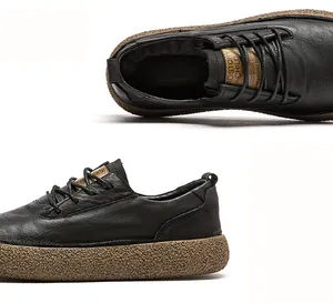 Detail shot of black leather men's casual shoes showing textured non-slip brown sole