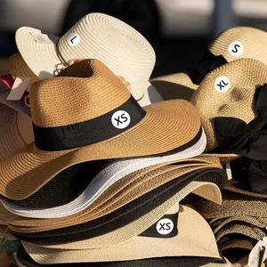 Macro view of white round self-adhesive clothing size stickers XS S L XL on hats