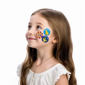 Little girl showing motivational reward stickers on her cheek in a bright setting