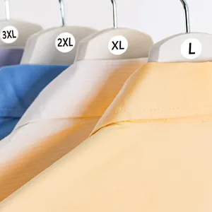 Close-up of 2.5cm round self-adhesive clothing size stickers on garment hangers.