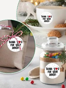 Close-up of 1-inch round Thank You stickers used on various gift packaging types