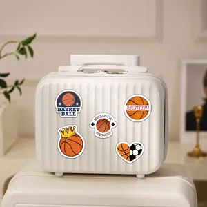 Detailed view of various cute cartoon basketball stickers on a white textured suitcase surface