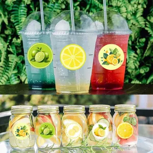 Variety of round cartoon lemon and lime stickers applied to plastic cups and glass jars