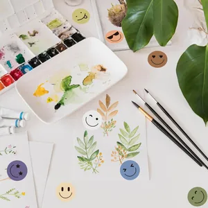 Detail shot of colorful smiley reward stickers used on a watercolor art project.