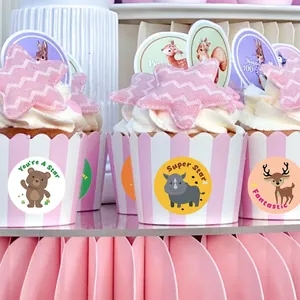 Detailed view of cartoon animal reward stickers on pink striped cupcake liners
