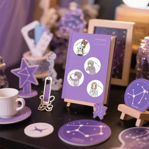 Close-up view of cute cartoon zodiac character stickers on a purple notebook cover
