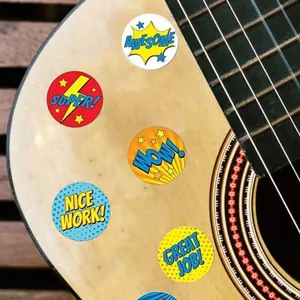 Close-up of colorful pop-art reward stickers applied on a guitar surface
