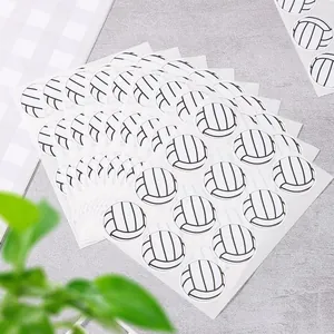 Macro view of round volleyball stickers on sheets for sports party decor and gift sealing