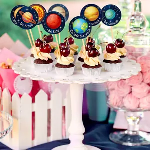 Cupcakes decorated with Solar System planet stickers featuring motivational English phrases