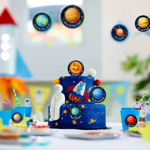 Detailed view of solar system stickers with inspirational phrases on a space-themed cake.