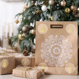 Detail view of gold foil Christmas tree stickers on brown gift packaging