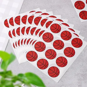 Detailed view of stacked basketball-themed round adhesive stickers for sports party decor