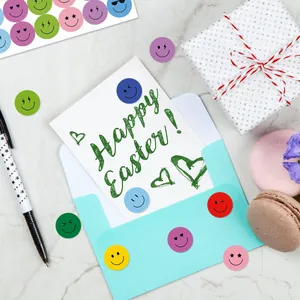 Colorful smiley face stickers decorating a Happy Easter card in a lifestyle setting.
