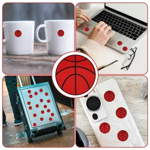 Detailed view of round red basketball stickers used on laptops, mugs and luggage