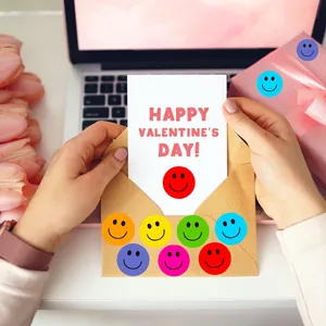 Detailed view of colorful smiley face reward stickers on a Valentine's Day envelope.