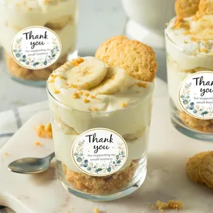 Close-up of floral Thank You stickers applied to dessert cups with fresh banana pudding
