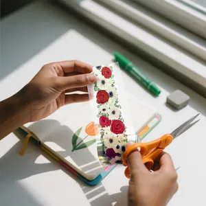 Detailed view of decorative floral PET tape being cut for scrapbooking and DIY journals