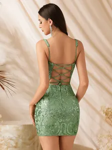 Detailed macro view of the back criss-cross straps on a green sequined evening mini dress.