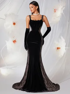 Elegant black velvet mermaid evening gown with lace sides and corset boning details.