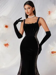 Elegant black velvet mermaid gown featuring side lace panels and long opera gloves.