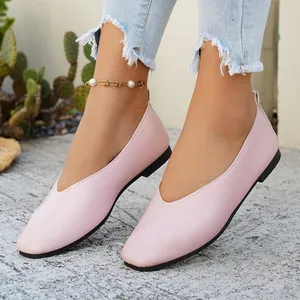 Close-up of minimalist pink square toe flat shoes for women in a retro style.