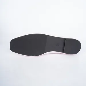 Detailed macro view of the black non-slip outsole and size mark on pink flat shoes