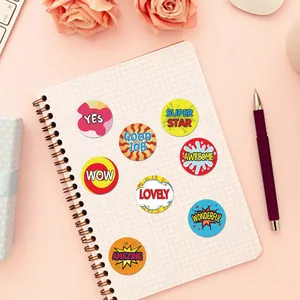 Detail of colorful motivational reward stickers with positive English words on a notebook