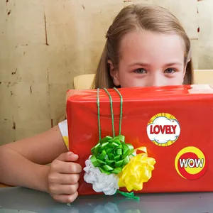 Children's reward stickers "LOVELY" and "WOW" applied to a red gift box