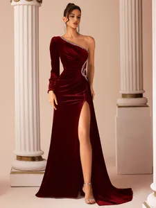 Full view of burgundy velvet one-shoulder gown displayed on model in classical studio