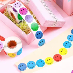 Close-up of colorful smiley face reward stickers on rolls used for gift packaging.