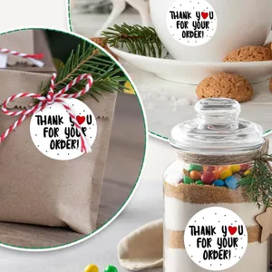 Detailed view of 'Thank you for your order' stickers on various gift packages and jars.