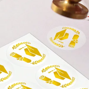 Close-up of gold foil graduation cap stickers for envelopes and certificates