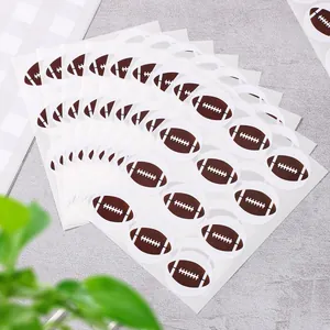 Stack of American football round stickers for sports themed party decorations and gift sealing