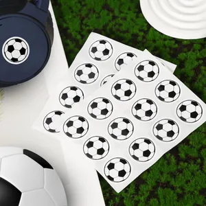 Close-up of circular soccer ball stickers on sheets for sports party decorations