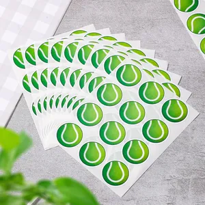 Close-up of green tennis ball pattern self-adhesive stickers for sports party decor.