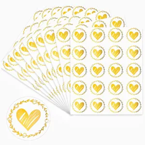 Close-up of gold heart floral wreath stickers for envelope sealing and decoration