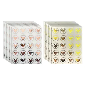 Macro detail of 20-piece gold and rose gold heart-shaped sealing stickers on sheets