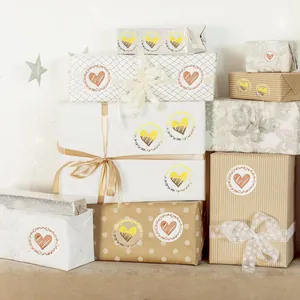 Decorative gold and rose gold heart envelope seal stickers on beautifully wrapped gift boxes