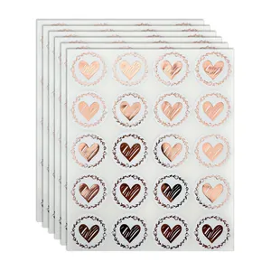 Detailed view of rose gold foil heart stickers with elegant wreath patterns