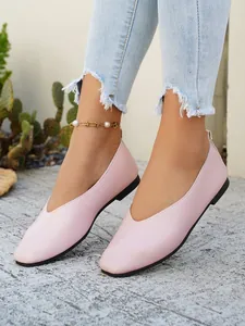 Pink textured leather flat shoes with V-cut design styled with light blue jeans