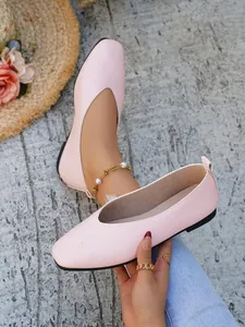 Detailed view of pink square toe women's ballet flats with textured leather finish