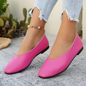 Close-up view of vibrant hot pink retro square-toe leather loafers on a model outdoors.
