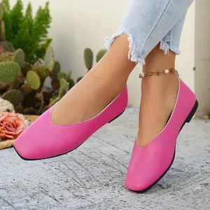 Detailed view of pink square toe flat shoes with textured leather and V-cut design