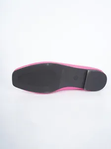 Detailed view of the durable black rubber outsole on a pink retro women's flat shoe