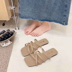 Sandali piatti beige a punta quadrata con sottili cinturini incrociati per l'estate