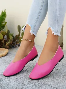 Detail view of pink leather loafers on model with ripped jeans and anklet