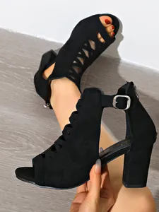 Detailansicht schwarzer Wildleder-Sandalen mit Blockabsatz und Schnürdesign