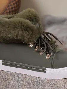 Detailed macro view of olive green winter snow boot with soft faux fur collar