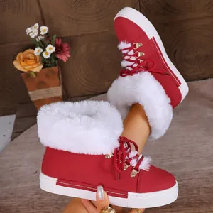 Detailed view of red women's snow boots featuring fluffy white fur lining and thick soles